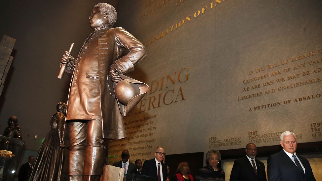 Vice President Mike Pence, right, takes a tour of the Smithsonian's National Museum of African American History and Culture, Tuesday, Feb. 13, 2018, in Washington. (AP Photo/Jacquelyn Martin)