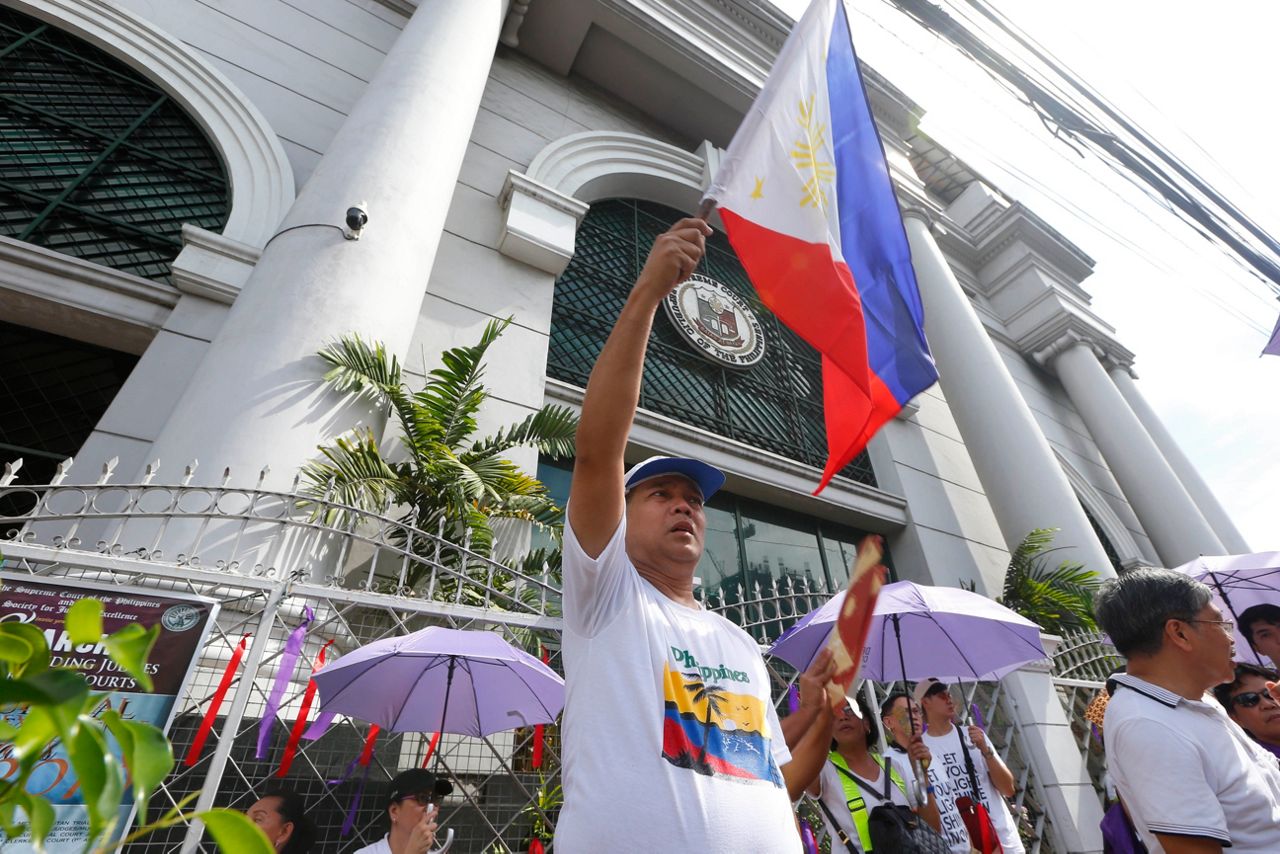 Protesters warn democracy at risk if Filipino justice ousted