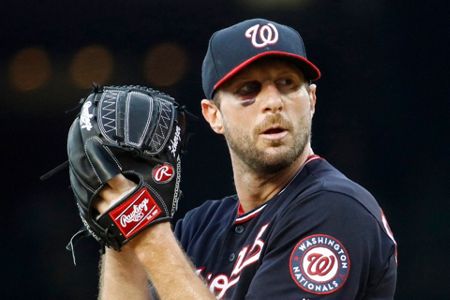 A bruise is visible below Washington Nationals starting pitcher Max  Scherzer's right eye as he stands in the dugout in the seventh inning of  the second baseball game of a doubleheader against