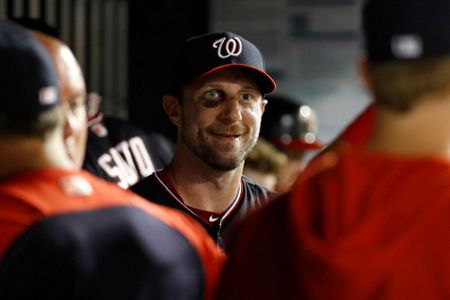 A bruise is visible below Washington Nationals starting pitcher Max  Scherzer's right eye as he stands in the dugout in the seventh inning of  the second baseball game of a doubleheader against