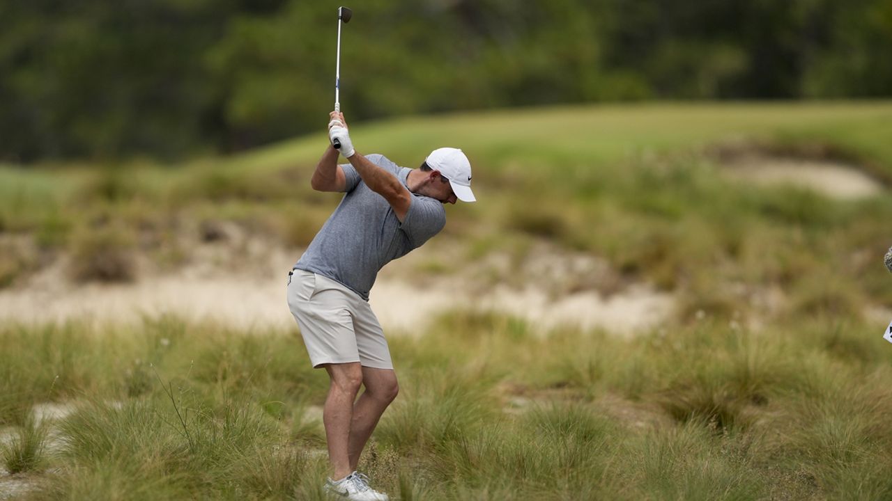 Rory McIlroy, of Northern Ireland, hits from the native area on the third hole during a practice round for the U.S. Open golf tournament Wednesday, June 12, 2024, in Pinehurst, N.C. (AP Photo/Matt York)