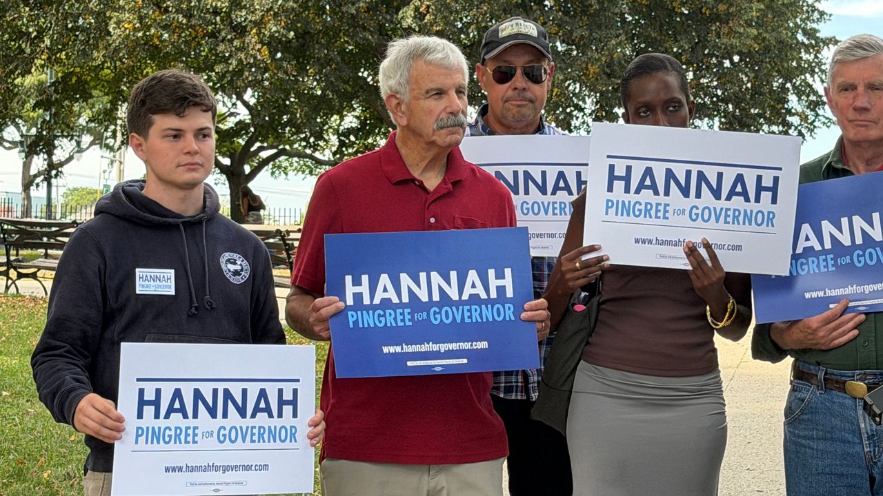 Former Republican state Sen. Roger Katz, in red, stands with other Hannah Pingree supporters on Wednesday in Portland. (Spectrum News/Susan Cover)