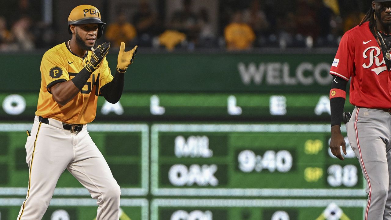 Pittsburgh Pirates outfielder Bryan De La Cruz celebrates after driving in a run against the Cincinnati Reds in the fifth inning of a baseball game, Friday, Aug. 23, 2024, in Pittsburgh. (AP Photo/Barry Reeger)