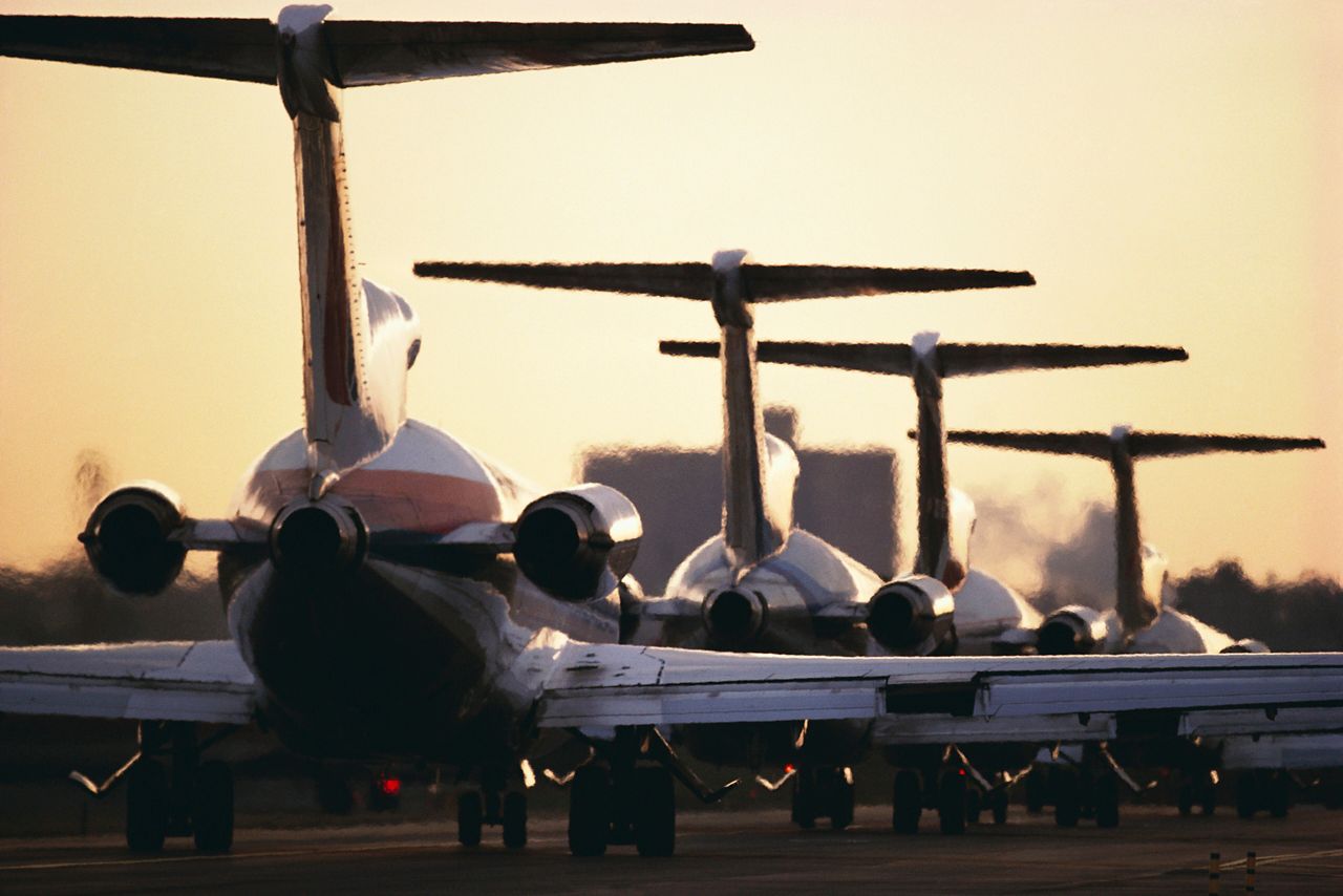 Airline jets lined up on runway. (Getty Images)