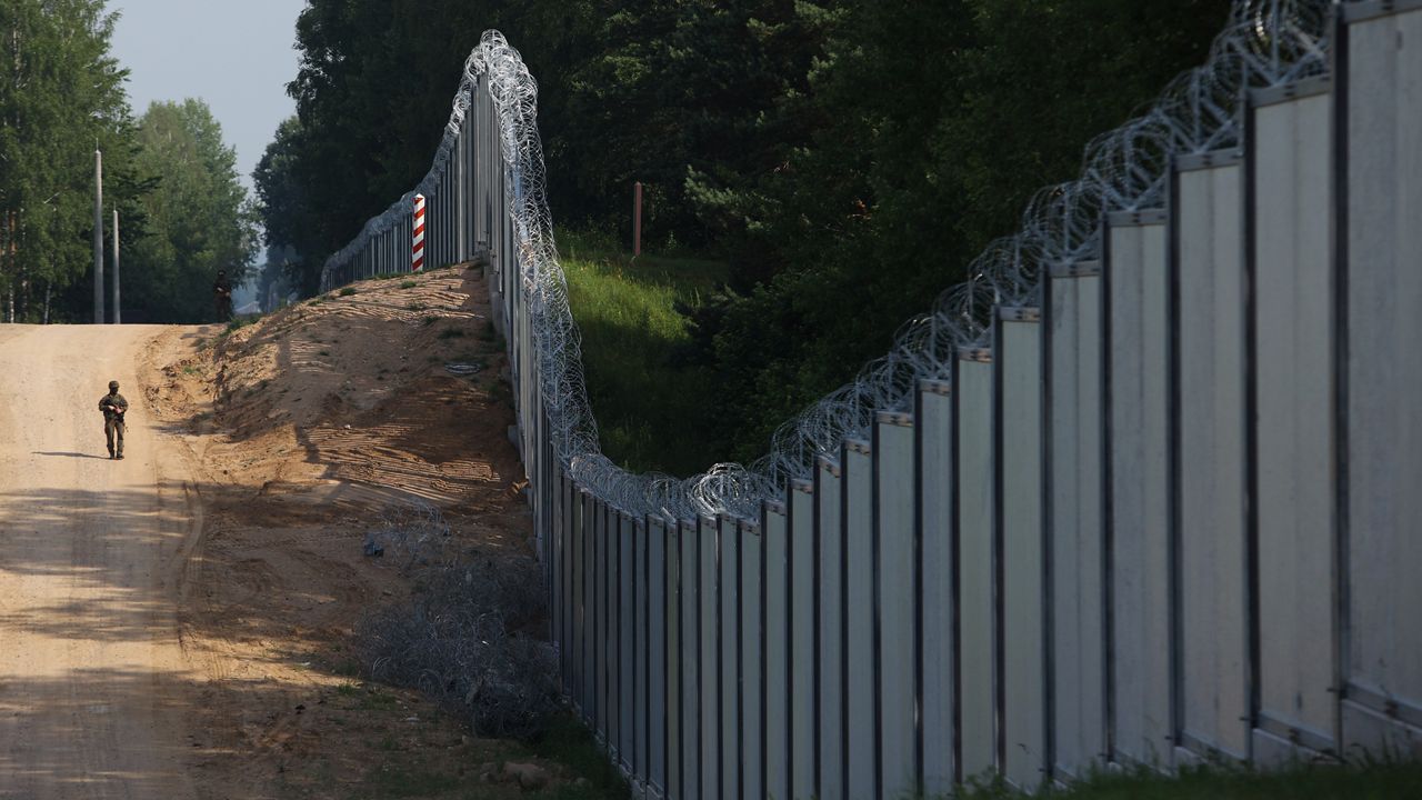 A Polish border guard patrols the area of a built metal wall on the border between Poland and Belarus, near Kuznice, Poland, on June 30, 2022. Poland's Defense Minister said Thursday, Aug. 10, 2023 that the country intends to put 10,000 soldiers along its border with Belarus, a statement that comes as Warsaw worries about migrants and Russian-linked mercenaries coming across its border. (AP Photo/Michal Dyjuk, File)
