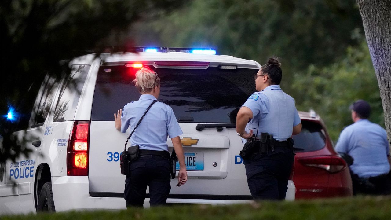 Police take up positions near the scene of a shooting Saturday, Aug. 29, 2020, in St. Louis. Ten years after gaining local control of its police for the first time since the Civil War, the city of St. Louis has even more murders than before — and Missouri lawmakers are again considering a state takeover of the police force. (AP Photo/Jeff Roberson, File)