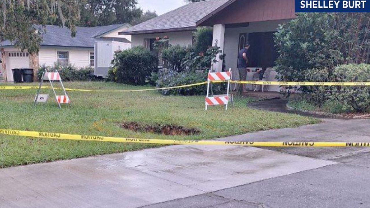 The sinkhole, found next to the drive way of the Highland City home on Royal Crest Drive appears to be near where a previous hole opened in January. (Shelley Burt)