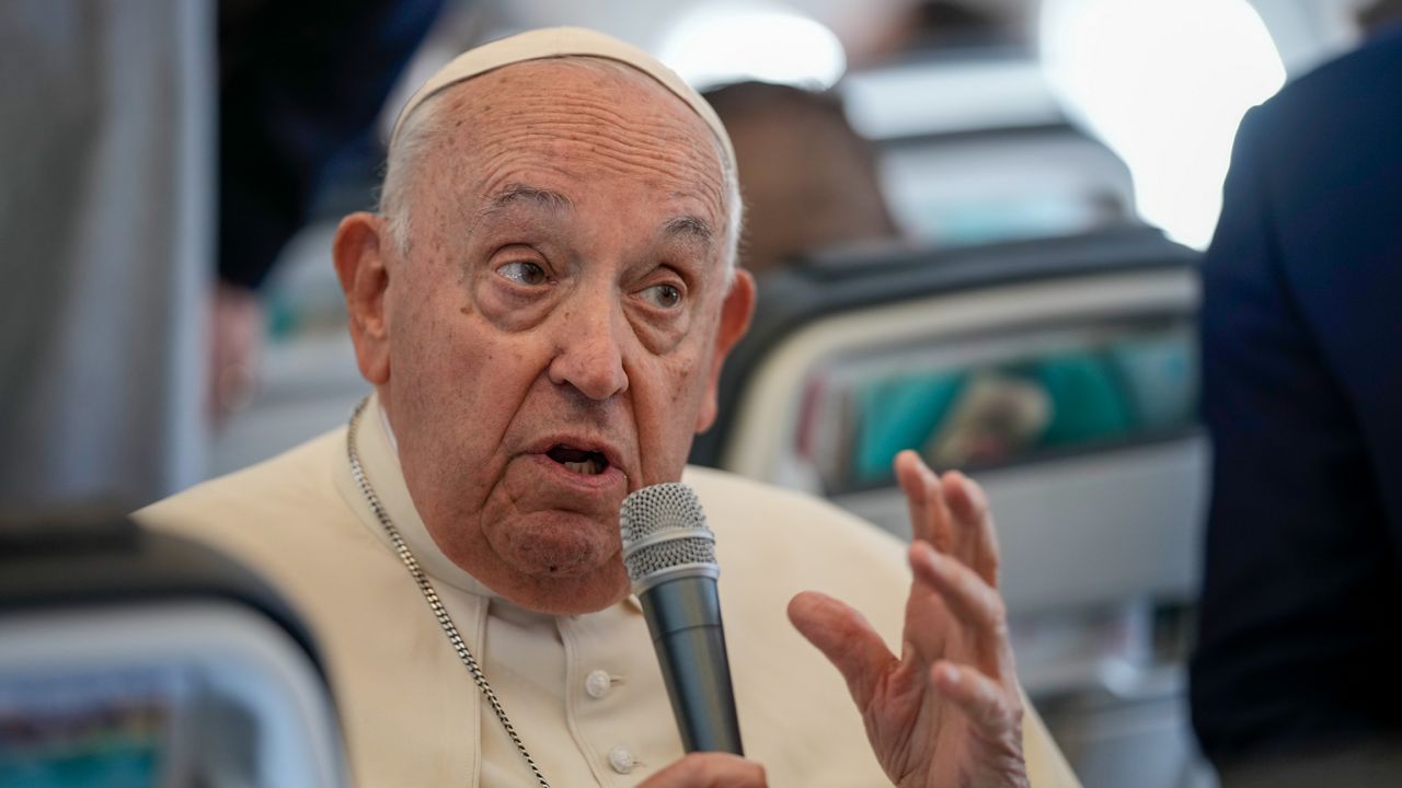 Pope Francis talks to journalists on the flight back to Rome at the end of his four-day visit to Belgium and Luxembourg, Sunday, Sept. 29, 2024. (AP Photo/Andrew Medichini, Pool)