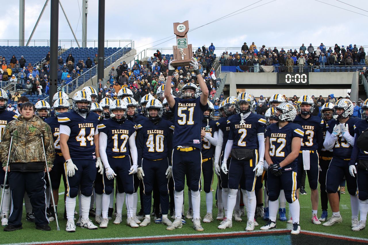 The Jeromesville Hillsdale High School football team raises the state runner-up trophy after the OHSAA Division VII football state championship game at Tom Benson Hall of Fame Stadium on Friday.