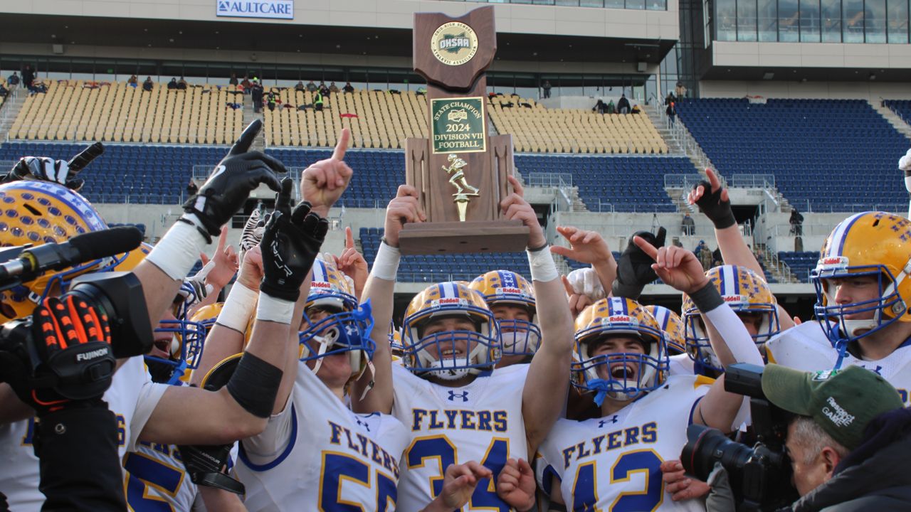 Maria Stein Marion Local senior running back Drew Lause hoists the state championship trophy after the OHSAA Division VII football state championship game at Tom Benson Hall of Fame Stadium on Friday.