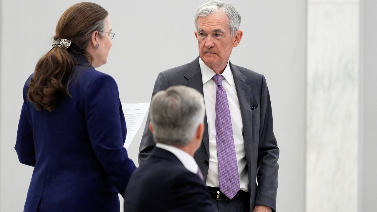Federal Reserve Chairman Jerome Powell, right, stands before speaking at the 75th anniversary conference of the Federal Reserve Board's International Finance Division at the Federal Reserve in Washington, Monday, June 2, 2025. (AP Photo/Mark Schiefelbein)
