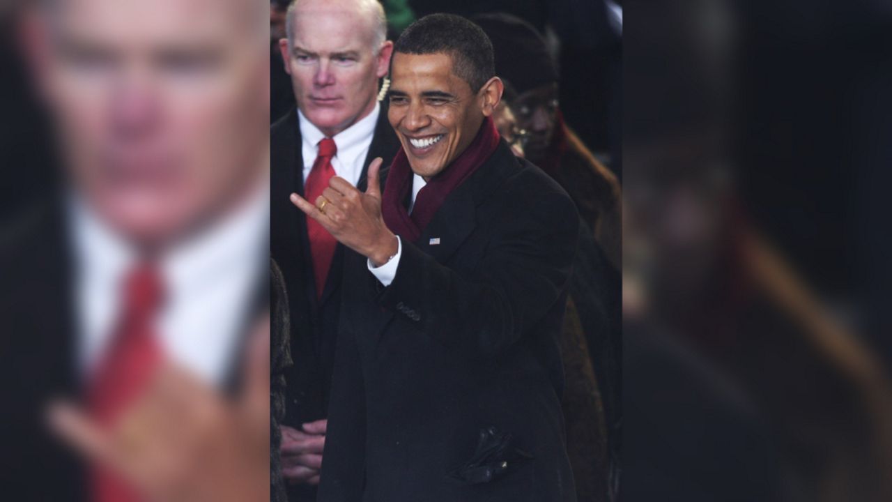 President Barack Obama gives the Hawaiian "shaka""hang loose" gesture during the inaugural parade in Washington, Tuesday, Jan. 20, 2009. (AP Photo/Pablo Martinez Monsivais)