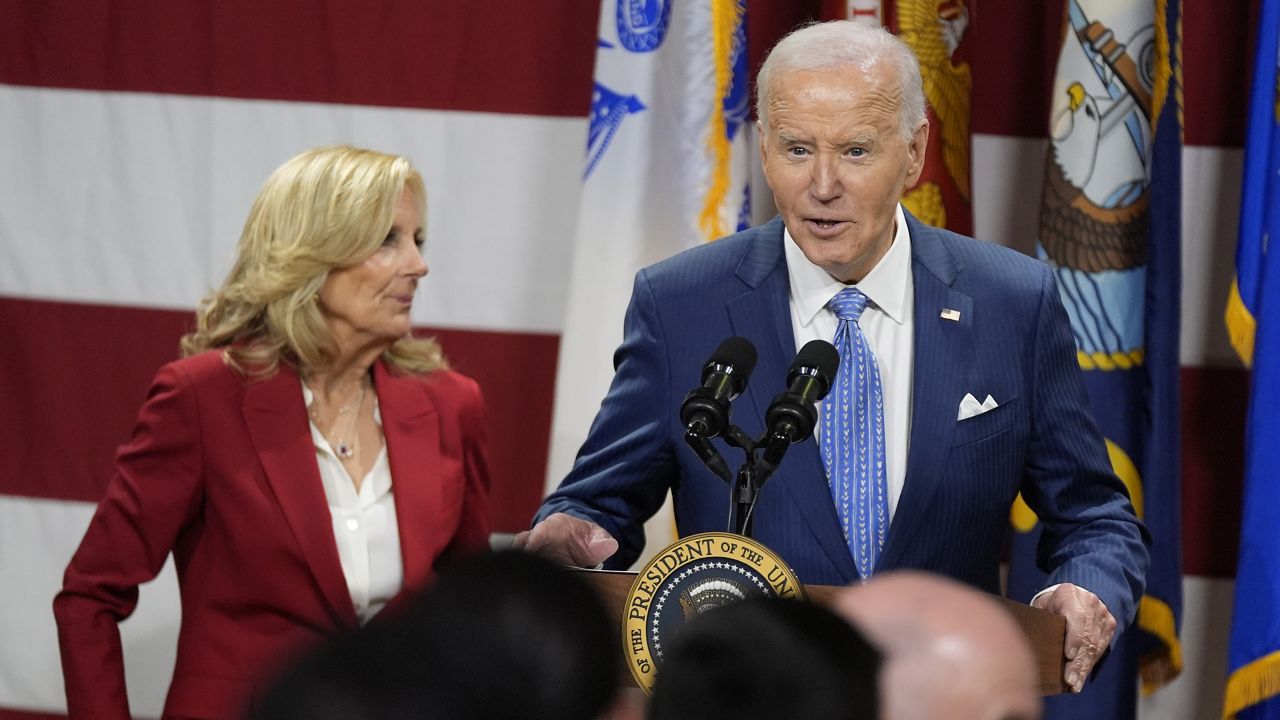 President Joe Biden speaks as first lady Jill Biden looks on at a Friendsgiving event with service members and their families in the Staten Island borough of New York, Monday, Nov. 25 2024. (AP Photo/Manuel Balce Ceneta)