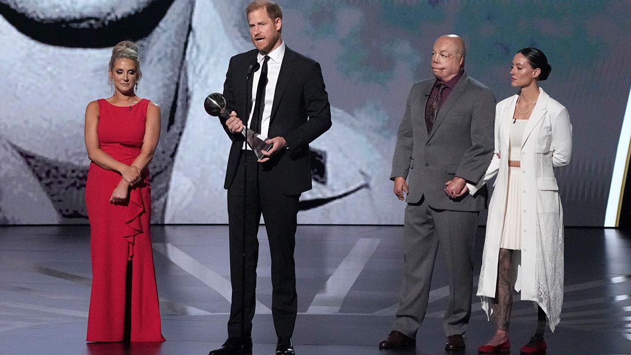 Prince Harry speaks after receiving the Pat Tillman Award For Service at the ESPY awards on Thursday, July 11, 2024, at the Dolby Theatre in Los Angeles. Looking on are Kirstie Ennis, Israel Del Toro, and Elizabeth Marks, right. (AP Photo/Mark J. Terrill)