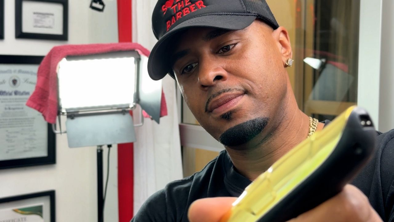 Principe Virtuez cutting hair. (Spectrum News 1/Dan Reidy)