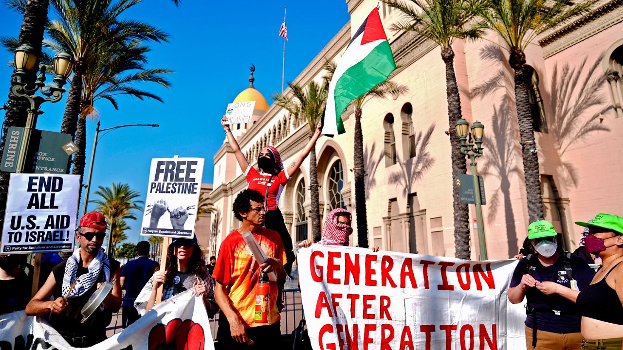 Pro-Palestinian demonstrators rally at the Shrine Auditorium where a commencement ceremony for graduates from Pomona College was being held Sunday, May 12, 2024, in Los Angeles. (AP Photo/Ryan Sun)