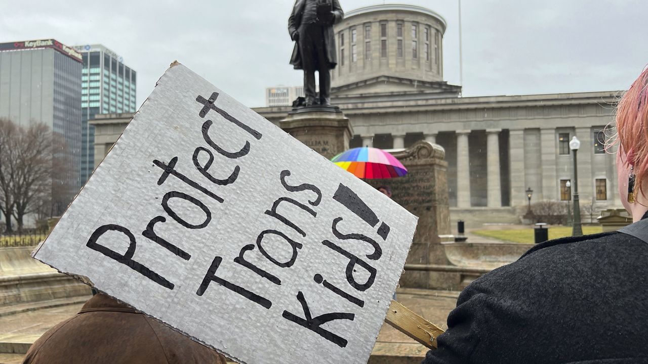 Protesters advocating for transgender rights and healthcare stand outside of the Ohio Statehouse, Jan. 24, 2024, in Columbus, Ohio. (AP Photo/Patrick Orsagost, File)