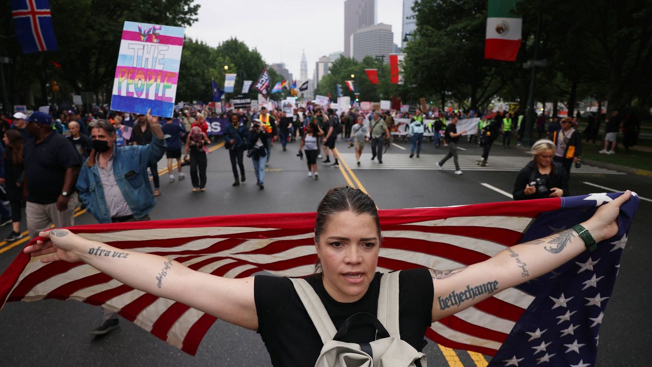Demonstrators march down Benjamin Franklin Parkway during the 