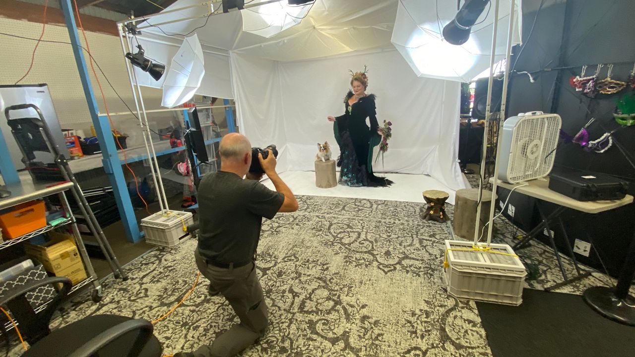 "Queen Elizabeth I," also known as Kate Hopkins, 51, of Lancaster, Penn., poses in her "Dark fairy queen" outfit for photographer John Rondeau at the Acton Fairgrounds on Friday. Hopkins is appearing this weekend in the Maine Renaissance Faire. (Spectrum News/Sean Murphy)