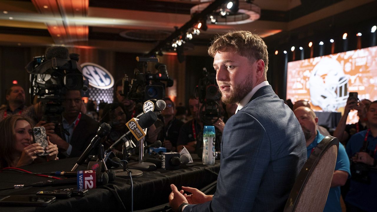 Texas quarterback Quinn Ewers speaks during the Southeastern Conference NCAA college football media days Wednesday, July 17, 2024, in Dallas. (AP Photo/Jeffrey McWhorter)