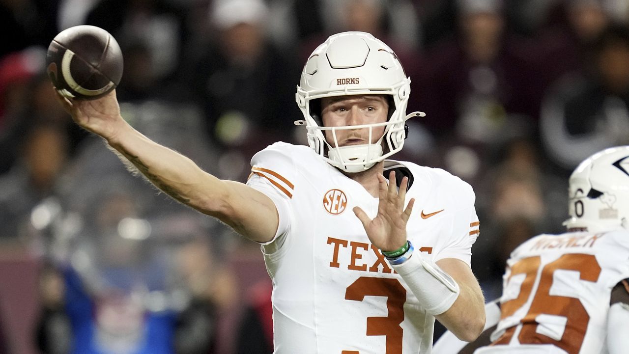 Texas quarterback Quinn Ewers (3) looks to pass to his running back against Texas A&M during the second half of an NCAA college football game Saturday, Nov. 30, 2024, in College Station, Texas. (AP Photo/Sam Craft)