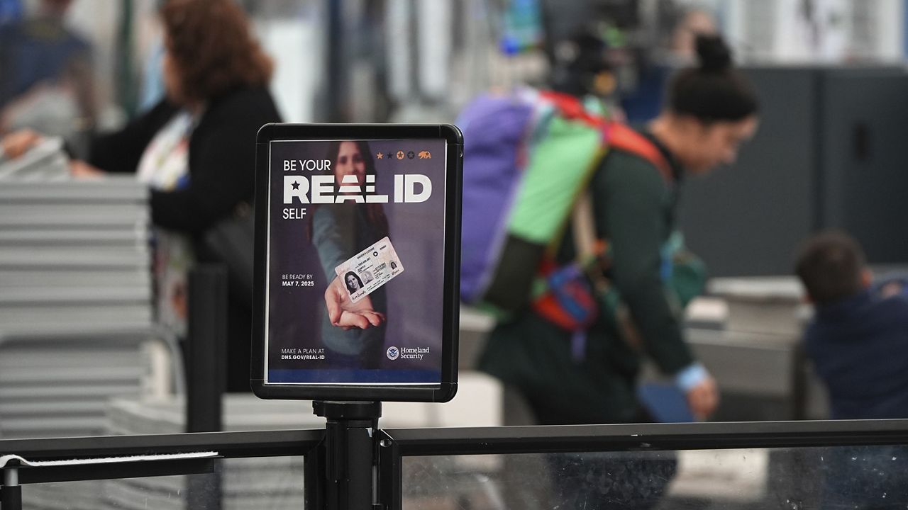 Sign displays need for passengers to produce Real ID documents at the south security checkpoint in Denver International Airport Wednesday, May 7, 2025, in Denver. 
