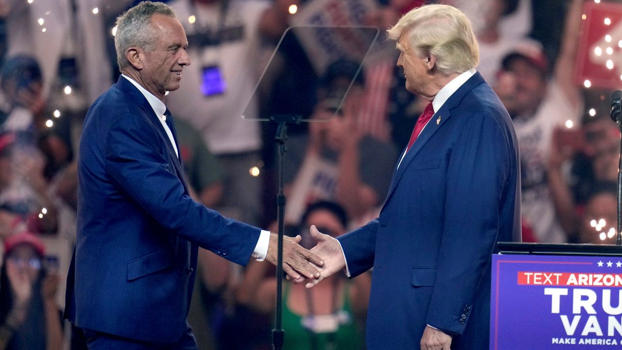 Independent presidential candidate Robert F. Kennedy Jr., left, shakes hands with Republican presidential nominee former President Donald Trump at a campaign rally Friday, Aug. 23, 2024, in Glendale, Ariz. (AP Photo/Ross D. Franklin)