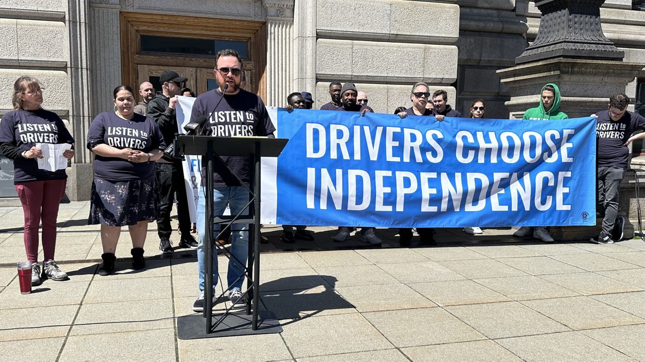 Drivers and advocates rallied behind Worcester City Hall on Tuesday. They are pictured.