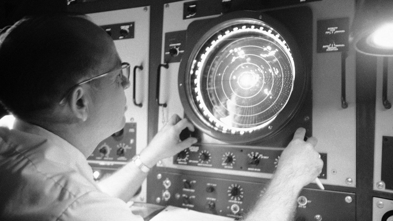 Radarscope at the National Hurricane Center in Miami reaches out 250 miles and aids weather forecasters in pinpointing hurricanes. Wilbur Mincey operates the dials on the scope on August 25, 1969 watching the cloud masses over Florida and the surroundings waters.