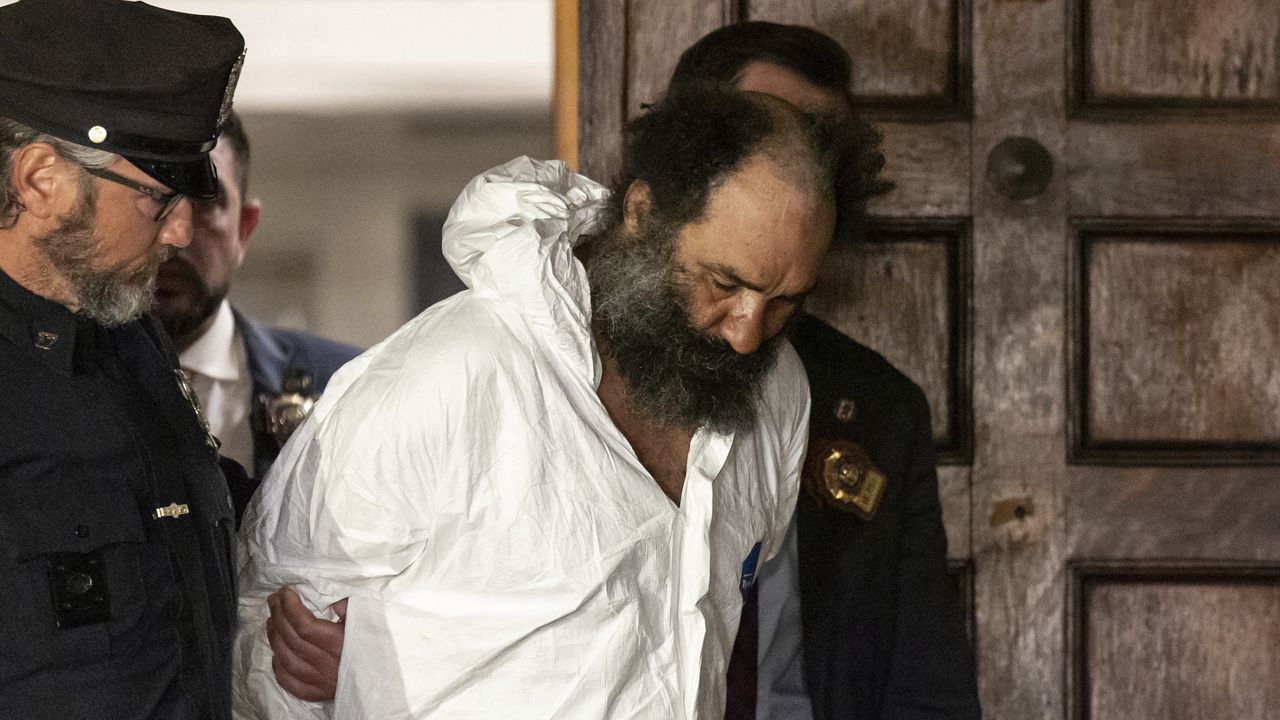 Ramon Rivera is escorted out of the 10th Precinct in Chelsea on Monday, Nov. 18, 2024. (AP Photo/Yuki Iwamura)