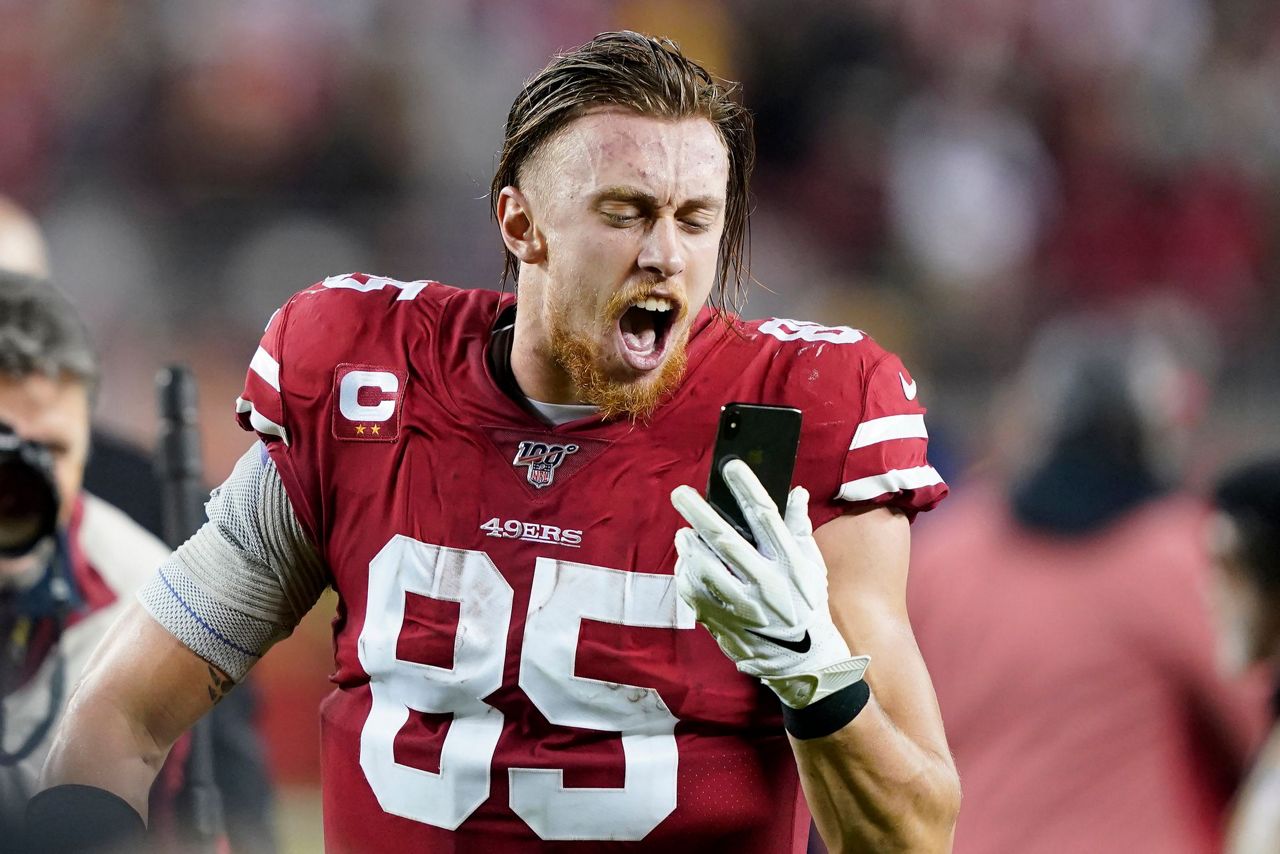 5 of 8. San Francisco 49ers tight end George Kittle yells into a phone whil...
