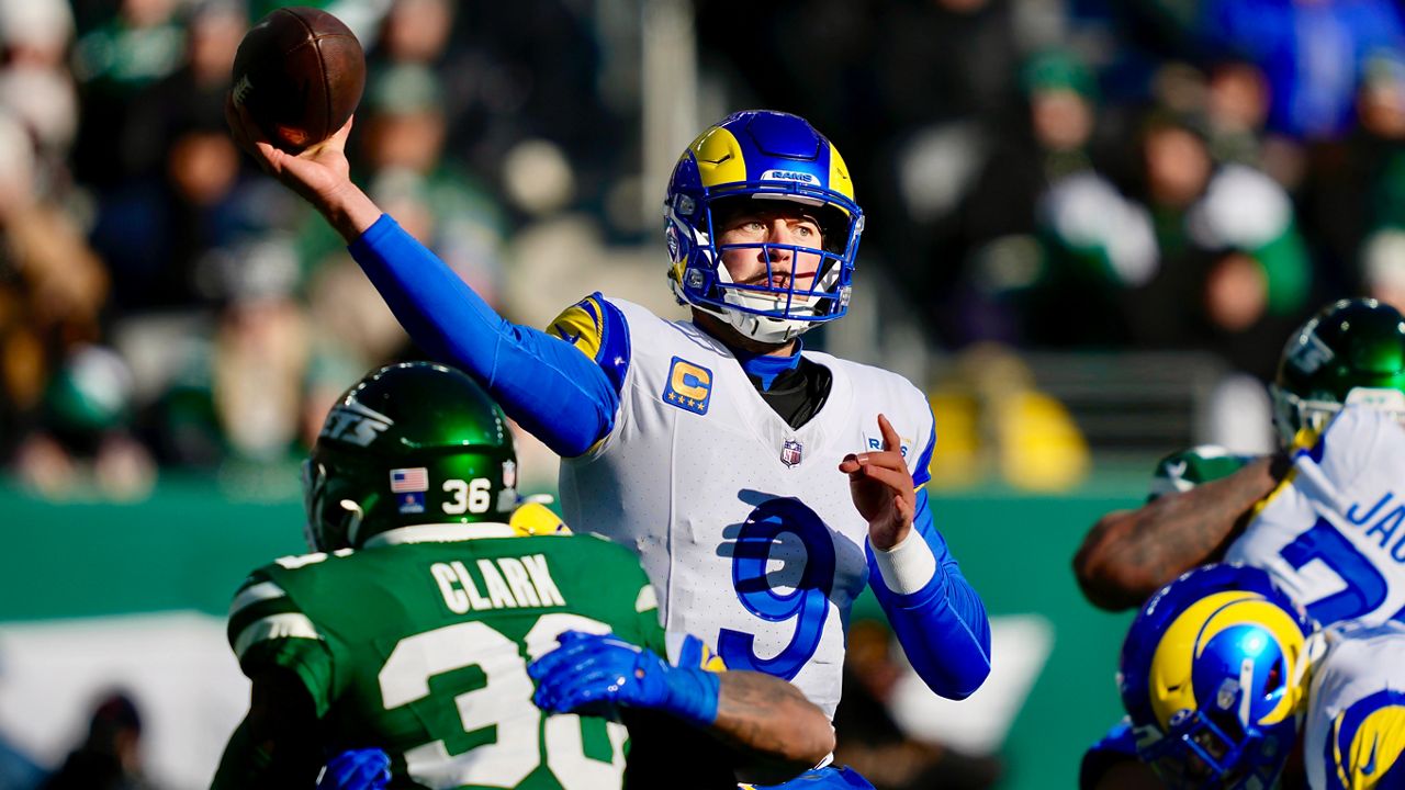 Los Angeles Rams quarterback Matthew Stafford (9) passes as New York Jets safety Chuck Clark, bottom left, applies pressure during the first half of an NFL football game in East Rutherford, N.J., Sunday, Dec. 22, 2024. (AP Photo/Julia Demaree Nikhinson)