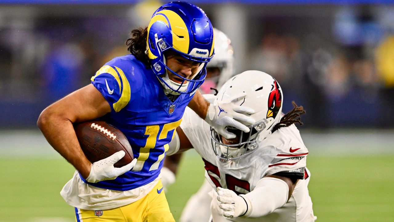 Los Angeles Rams wide receiver Puka Nacua (17) stiff-arms Arizona Cardinals defensive tackle Dante Stills (55) after a reception during the second half of an NFL football game Saturday, Dec. 28, 2024, in Inglewood, Calif. (AP Photo/Alex Gallardo)