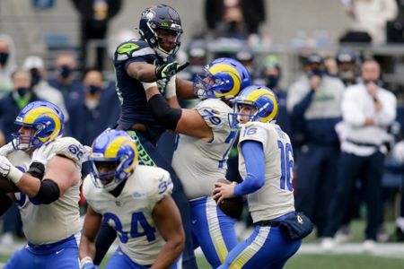Los Angeles Rams safety Nick Scott knocks away a pass intended for Seattle  Seahawks wide receiver Tyler Lockett during the second half of an NFL  wild-card playoff football game, Saturday, Jan. 9
