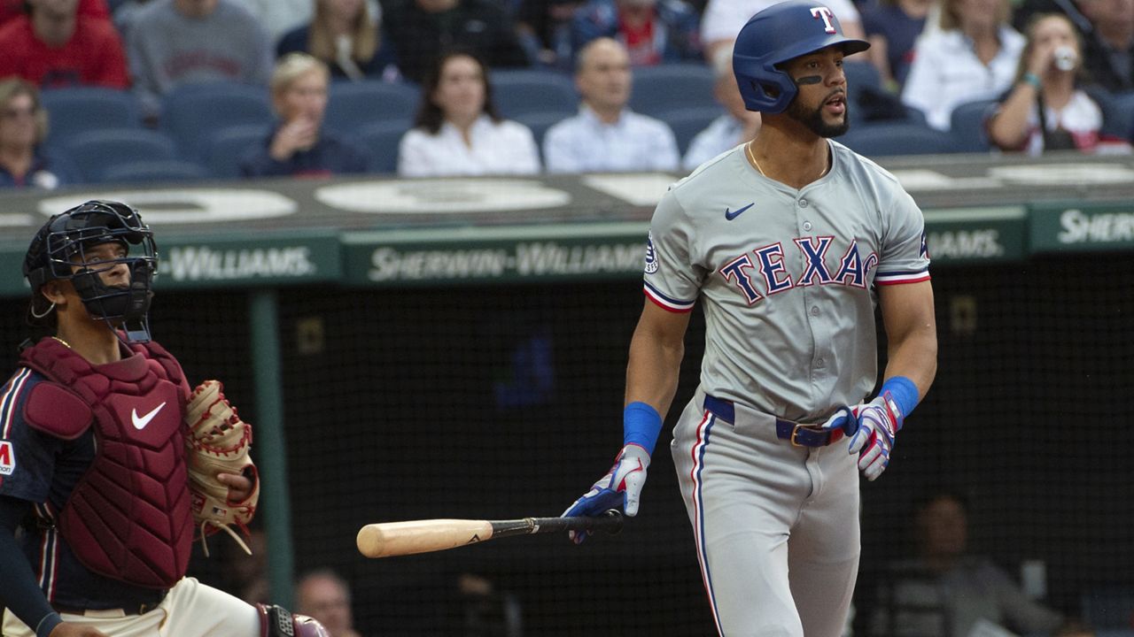 Texas Rangers' Leody Taveras, right, watches his two-run single off Cleveland Guardians starting pitcher Tanner Bibee with Guardians catcher Bo Naylor, left, during the second inning of a baseball game in Cleveland, Friday, Aug. 23, 2024. (AP Photo/Phil Long)