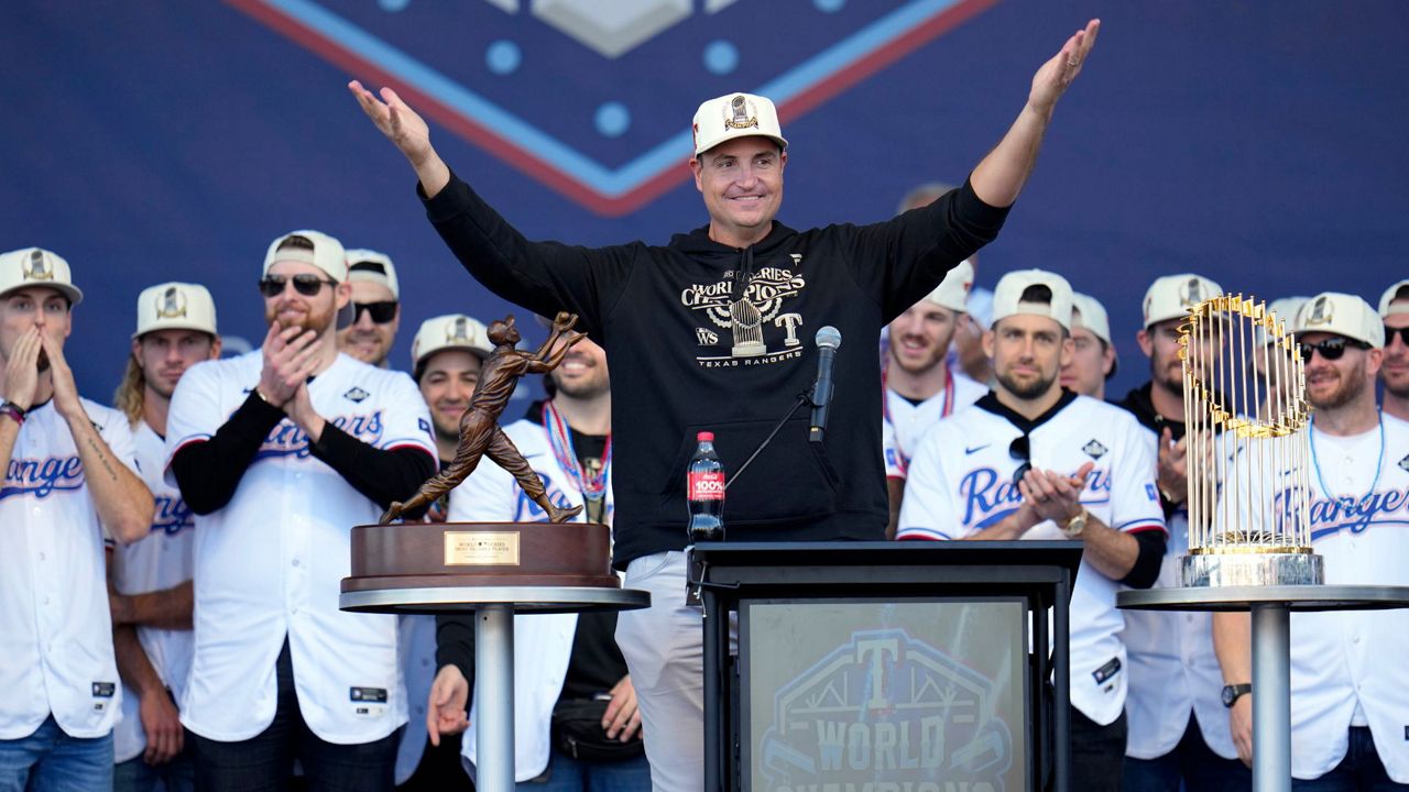 Texas Rangers general manager Chris Young, center, addresses fans during a World Series baseball championship celebration Nov. 3, 2023, in Arlington, Texas. (AP Photo/Julio Cortez, File)