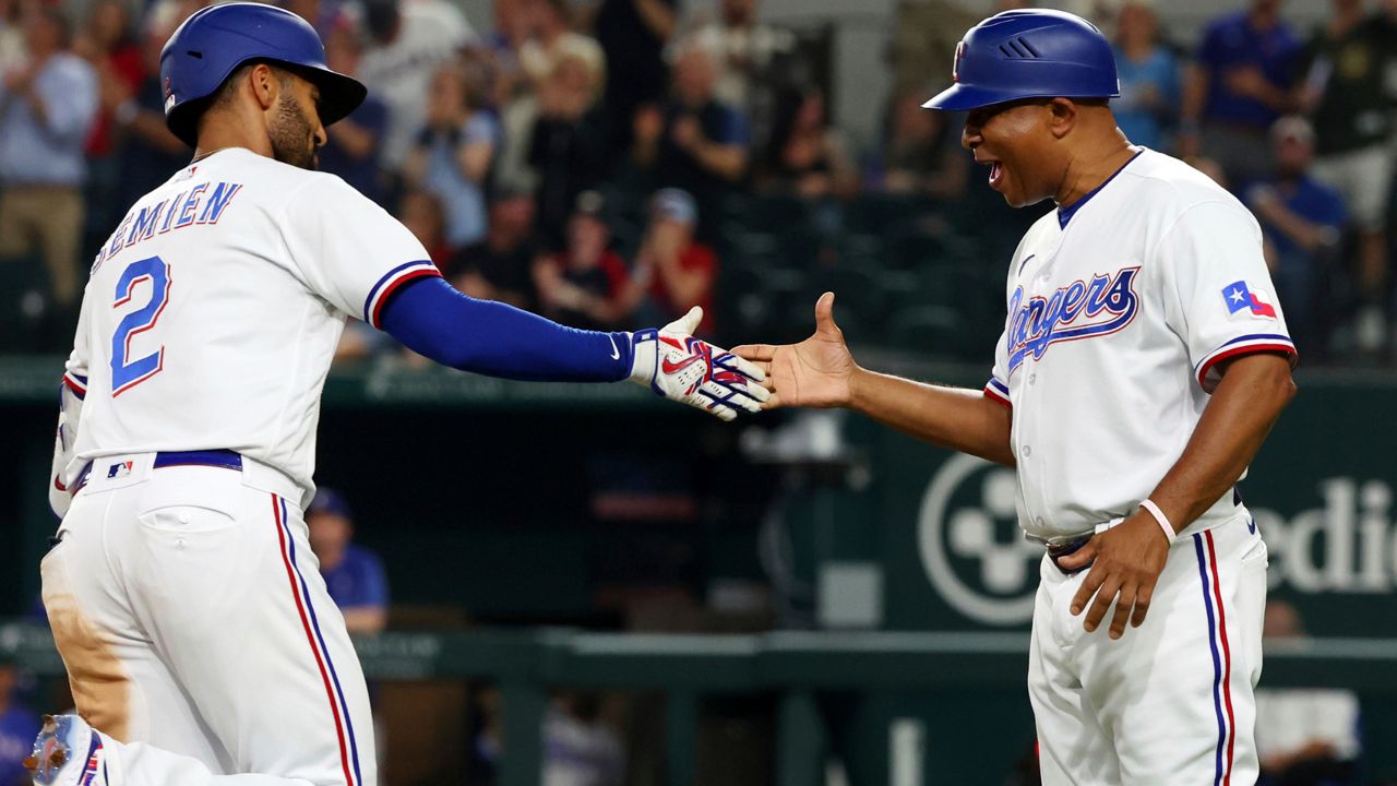 Marcus Semien of the Texas Rangers throws to first base in the