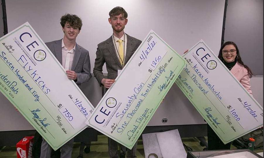 Chad Tjugum (center), a UW-Whitewater student, runs two coin collecting businesses. (