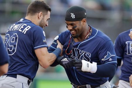 Tampa Bay Rays' Tommy Pham, right, is congratulated by Willy