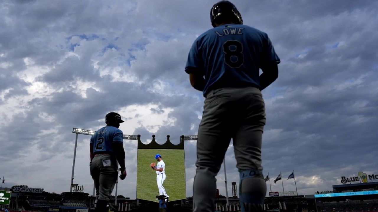 Tampa Bay's Yandy Diaz and Brandon Lowe wait amidst Tuesday's rain-delay during the Rays' eventual 5-1 victory. (AP Photo/Charlie Riedel)