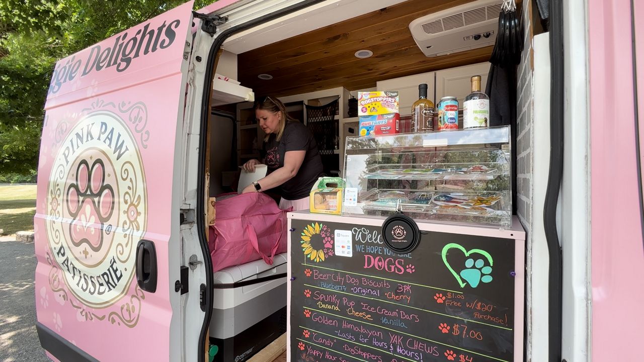 Rebecca White works in her newly opened food truck, Pink Pup Patisserie. (Spectrum News/Brian Farber)