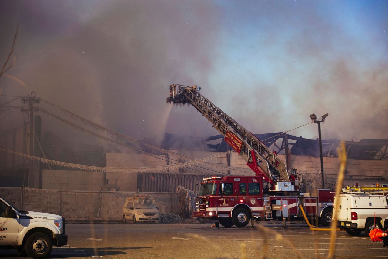 Crews battle flames, cold, wind in huge recycling plant fire