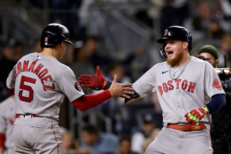 Boston Red Sox players, from left, Tommy Pham, Enrique Hernandez and Alex  Verdugo celebrate after beating