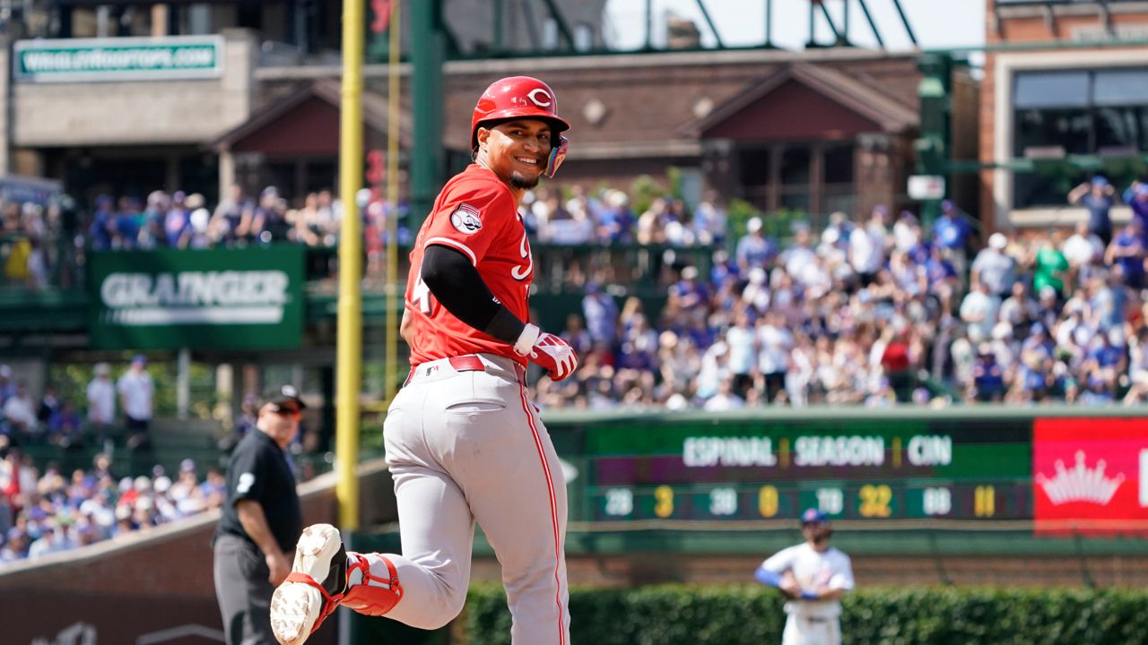 Cincinnati Reds' Santiago Espinal (4) runs the bases and looks back at the dugout after hitting a two-run home run against the Chicago Cubs during the seventh inning of a baseball game Friday, May 31, 2024, in Chicago. (AP Photo/David Banks)