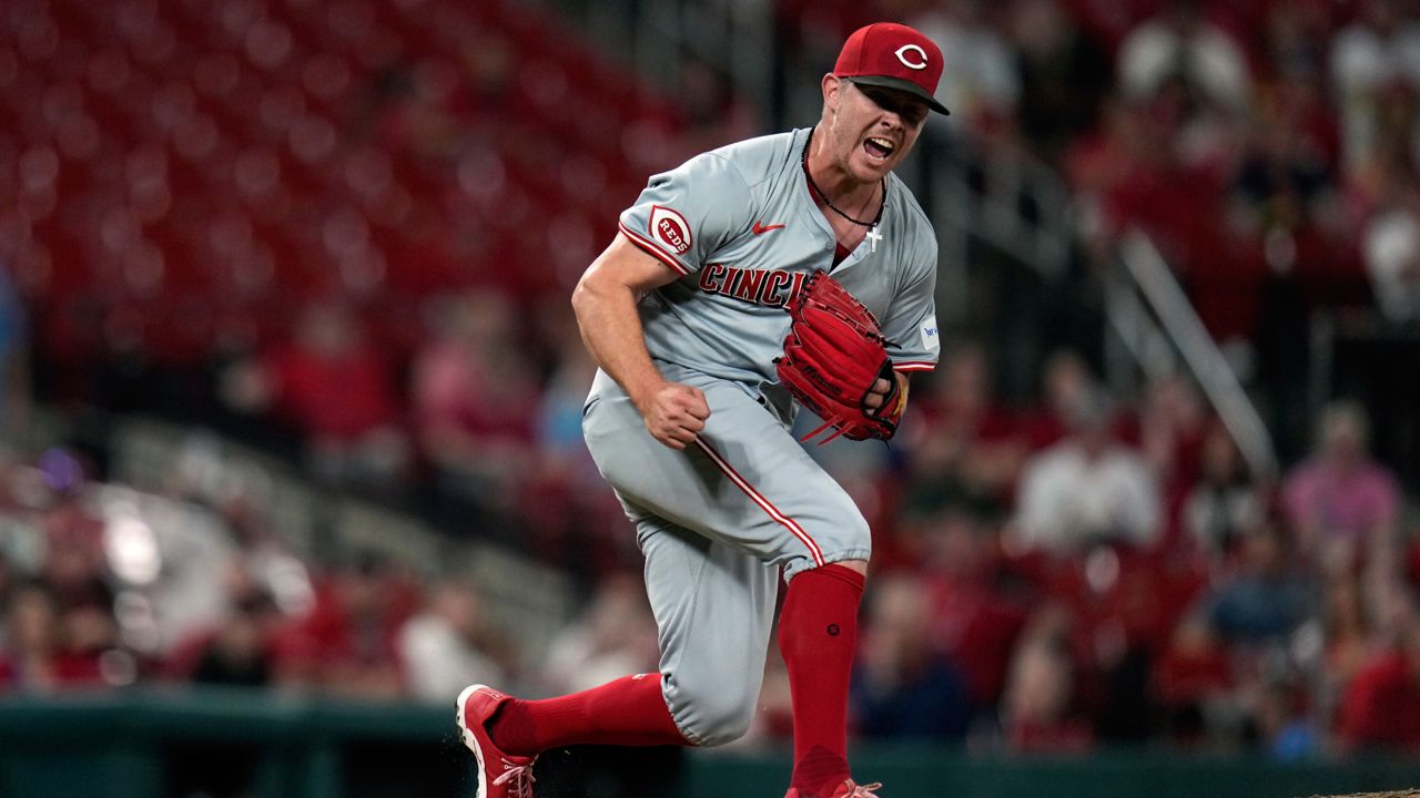 Cincinnati Reds relief pitcher Emilio Pagan celebrates after striking out St. Louis Cardinals' Matt Carpenter with the bases loaded to end a baseball game Tuesday, Sept. 10, 2024, in St. Louis. 