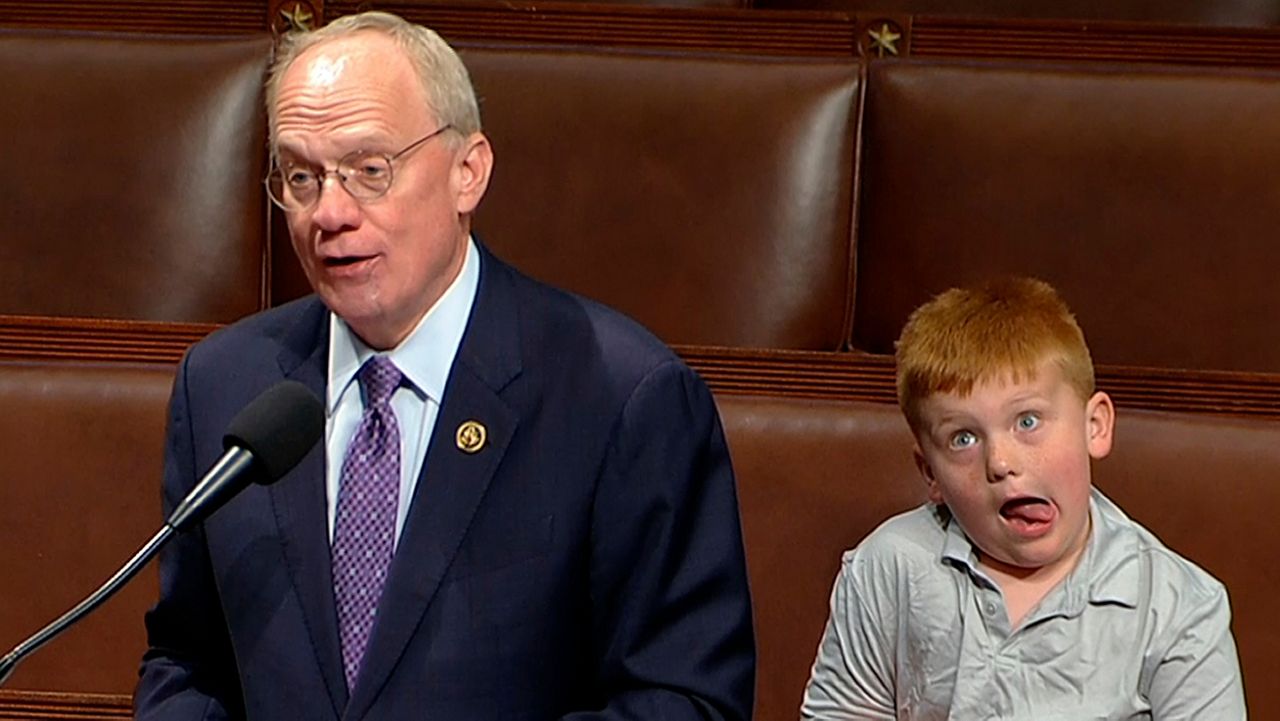 This image from House Television shows Rep. John Rose, R-Tenn., speaking on the floor of the House of Representatives Monday, June 3, 2024, in Washington, as his son Guy makes a face. (House Television via AP)