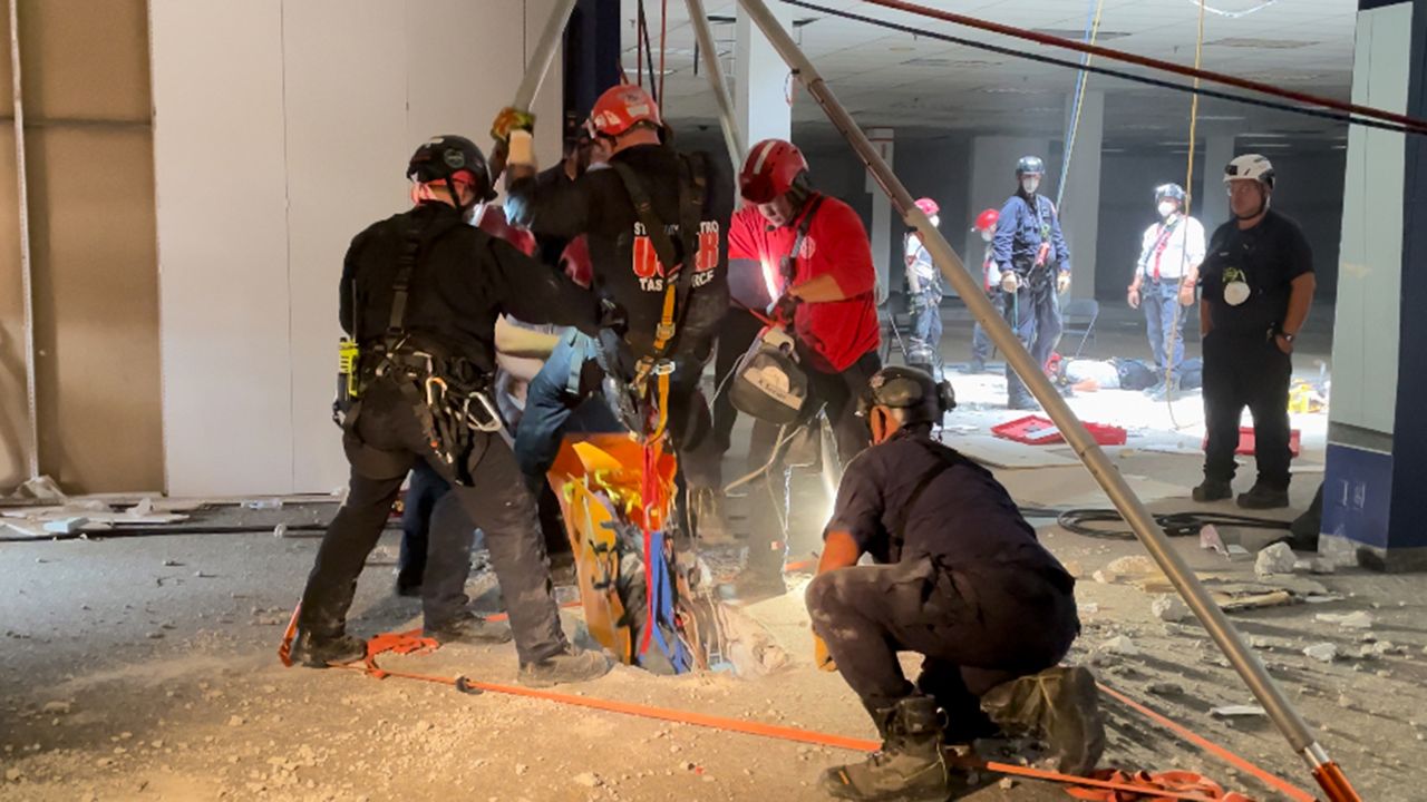 St. Louis-area search and rescue crews convey a first responder and a dummy victim from the basement of the Chesterfield Mall Friday afternoon. It was part of the simulation training. (Spectrum News/Elizabeth Barmeier)