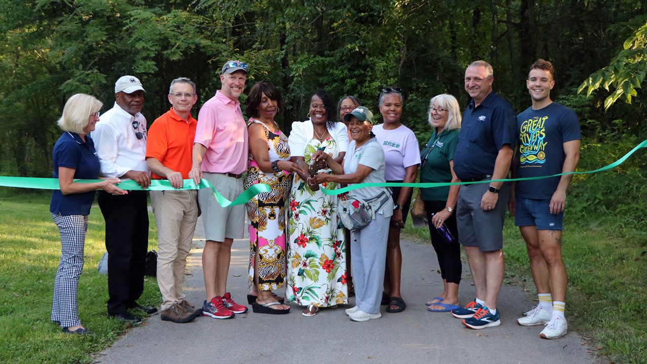 A ribbon cutting was held in St. Vincent County Park Thursday evening, which marked the opening of the northern section of the St. Vincent Greenway. Pictured are members of the Great River Greenway, Metro Transit, St. Louis County Parks, cities of Pagedale and Greendale and the Missouri Department of Transportation. (Spectrum News/Elizabeth Barmeier)