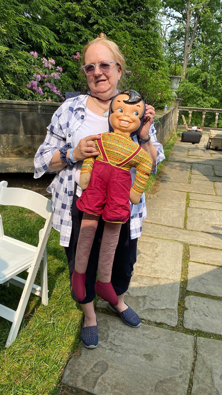 a woman holding a large doll