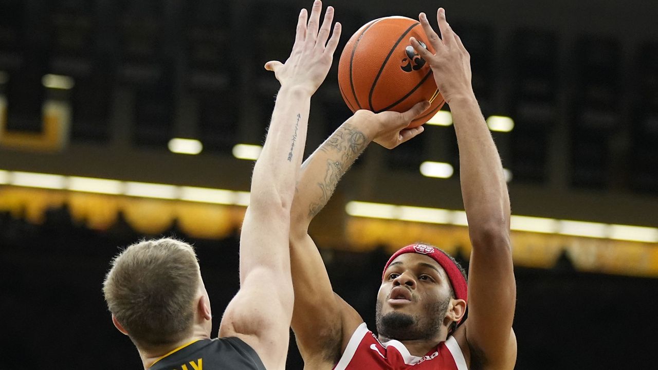 Ohio State guard Roddy Gayle Jr. (1) shoots over Iowa guard Josh Dix (4) during the first half of an NCAA college basketball game, Friday, Feb. 2, 2024, in Iowa City, Iowa. (AP Photo/Charlie Neibergall)